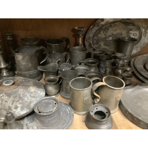 85 - A large quantity of pewter plates, measuring jugs, cups, candlesticks, bed pan, ink well, salt and p... 