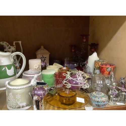 95 - A small collection of candle related items to include floral decorated candelabra, tealight holders,... 