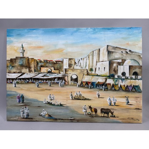 310 - Late 20th century Arab market scene, Libya, oil on canvas, signed N. Hsniefr 99', 75cm x 109cm