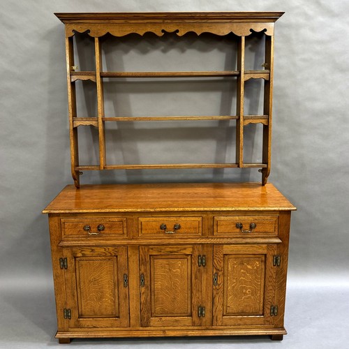 362 - Batheaston Furniture Makers: an oak reproduction dresser base, three short drawers above three doors... 