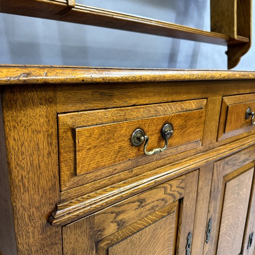 362 - Batheaston Furniture Makers: an oak reproduction dresser base, three short drawers above three doors... 