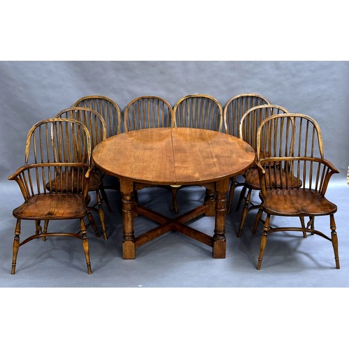 363 - Batheaston Furniture Makers: a large oak extending dining table with two additional leaves on x-fram... 