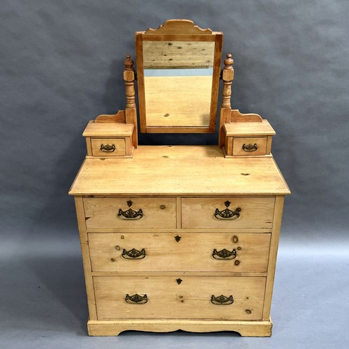 113 - A pine dressing table, two storage drawers to the horns, two short drawers above two long drawers, o... 