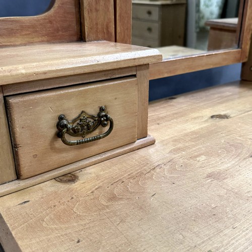 113 - A pine dressing table, two storage drawers to the horns, two short drawers above two long drawers, o... 