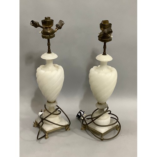 114B - A pair of white alabaster lamps, with twin light sconces, the bodies of wrythen baluster from on squ... 