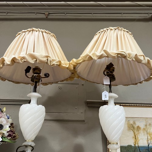 114B - A pair of white alabaster lamps, with twin light sconces, the bodies of wrythen baluster from on squ... 