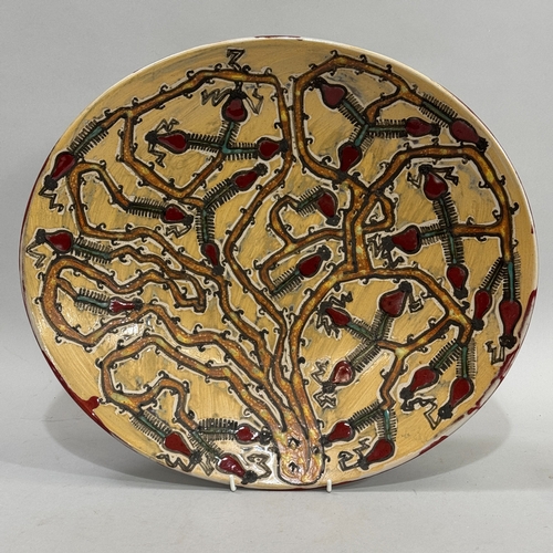 62 - Alexandra Copeland for Dartington Pottery, a large stoneware oval platter, painted with stylised fru... 