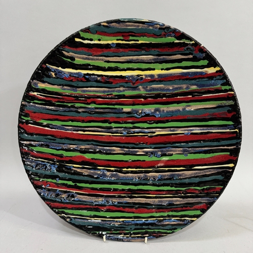 63 - Janice Tchalenko (1942-2018) for Dartington Pottery, a large circular charger glazed with stripes in... 