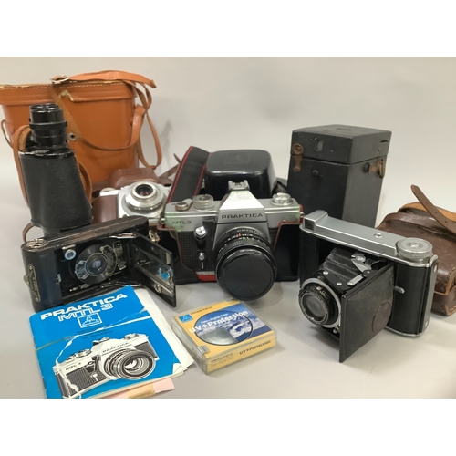 90 - A Voigtlander Bessa 66 camera in original leather case, a Praktica MTL3 SLR camera with original ins... 