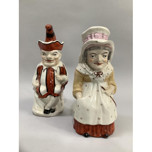 176 - A pair of Victorian Staffordshire figures in the form of Punch and Judy, measuring approximately 18c... 