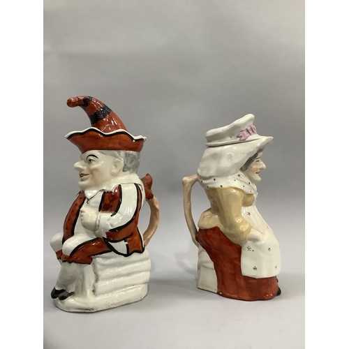 176 - A pair of Victorian Staffordshire figures in the form of Punch and Judy, measuring approximately 18c... 