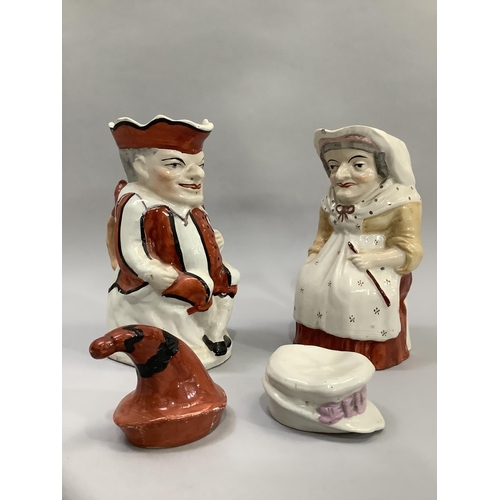 176 - A pair of Victorian Staffordshire figures in the form of Punch and Judy, measuring approximately 18c... 