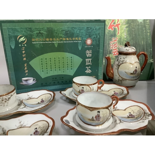 211 - A Chinese bamboo woven teapot decorated with pandas together with four teacups and a circular tray i... 