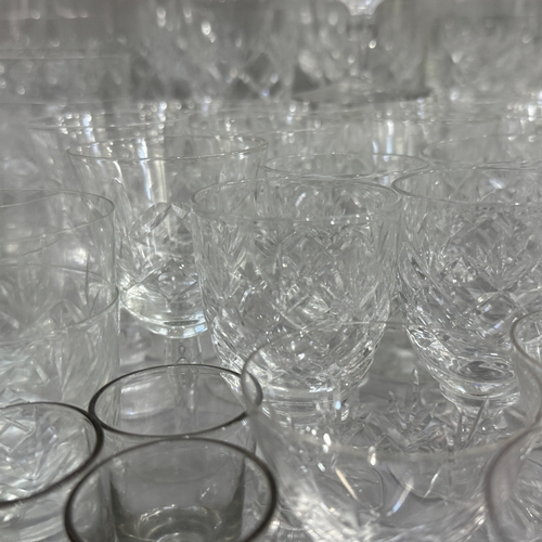 113 - A quantity of cut and etched table glass of  various designs including water glasses, ports, sherrie... 