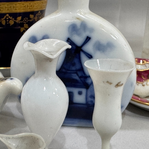 168 - A belleek jug and stand of moulded basket weave painted with shamrock, black printed mark, a Shelley... 