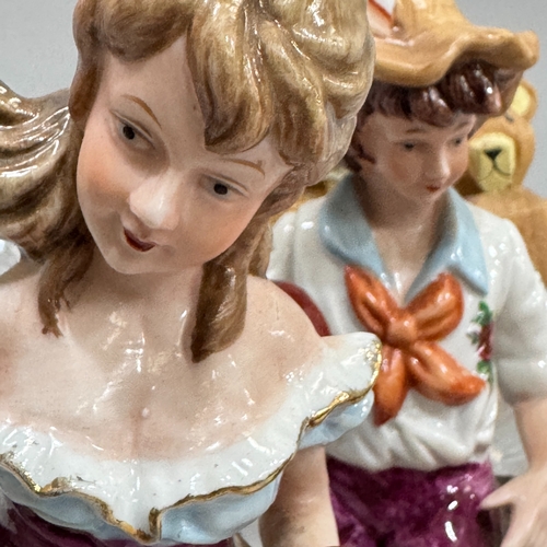 192 - A pair of continental figures, a boy and girl with geese, a novelty salt and pepper in the form of i... 