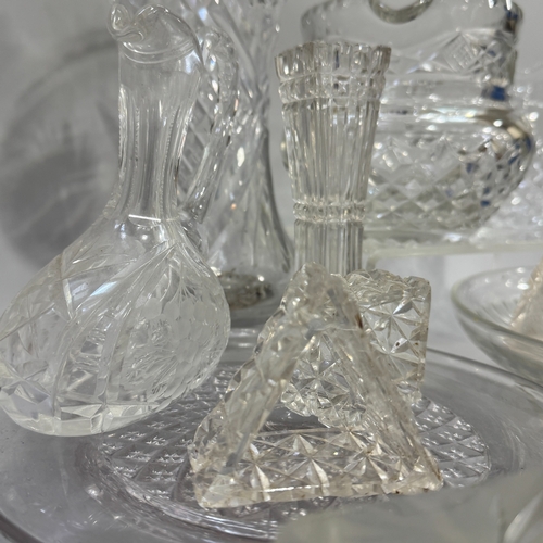 109 - Cut and moulded glassware including tall cut glass flower vase, water jug, cream jug, specimen vase,... 