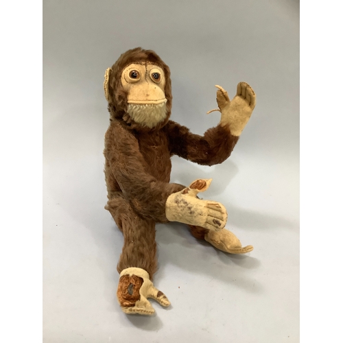 114 - A Steiff monkey with brown fur, pink face and paws, label to ear, worn condition together with a Poo... 