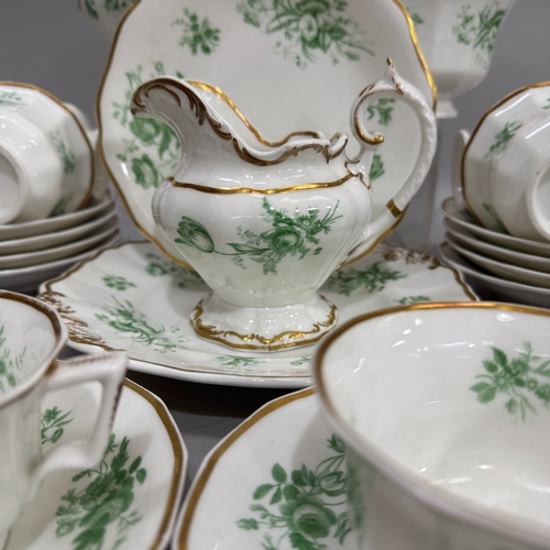 12 - A Rockingham style tea service printed with sprays of flowers in green and highlighted in gilt compr... 