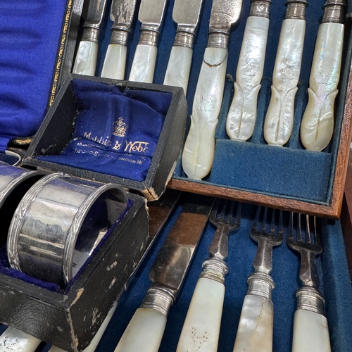 209B - A Victorian mahogany case of twelve mother-of-pearl handled dessert knives, a cased set of six silve... 