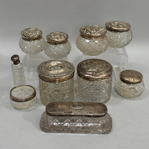 238 - Seven cut glass and silver lidded toilet jars, hair tidy, open salt and bottle c1910