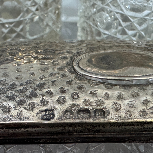 238 - Seven cut glass and silver lidded toilet jars, hair tidy, open salt and bottle c1910