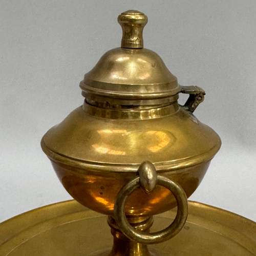 187 - A brass ink well of classical urn form with dome cover and ring handles on a circular dished base, 1... 