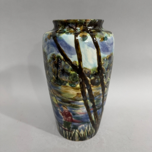 25 - A Cobridge stoneware vase painted with a continual river landscape  and angler, no. 7/50 impressed a... 