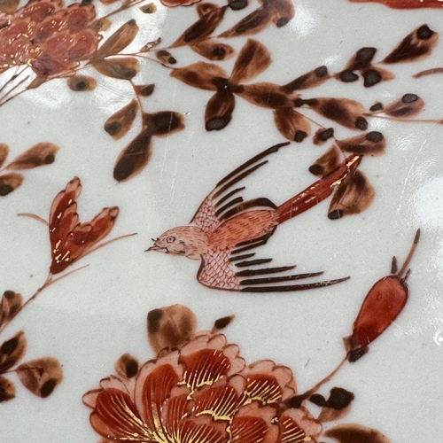 46 - A late 19th century Japanese charger painted in iron red and gilt painted with reserves of birds, pe... 