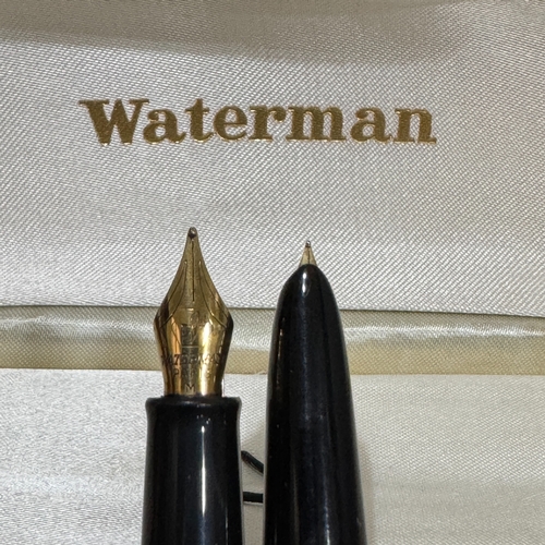 51 - A Watermans fountain pen of blue marbled finish, gilt clip, together with a black and gilt Watermans... 