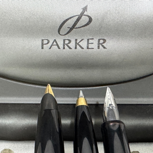 53 - A Parker 45 fountain pen in black with brushed white metal and gilt case together with a similar rol... 