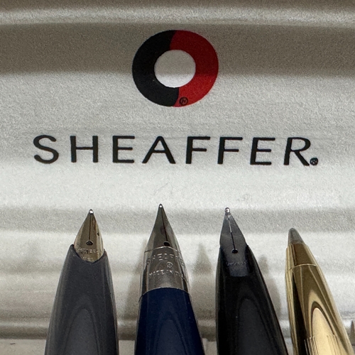 58 - Three Sheaffer fountain pens in grey and gilt case, blue and brushed white metal, black and polished... 