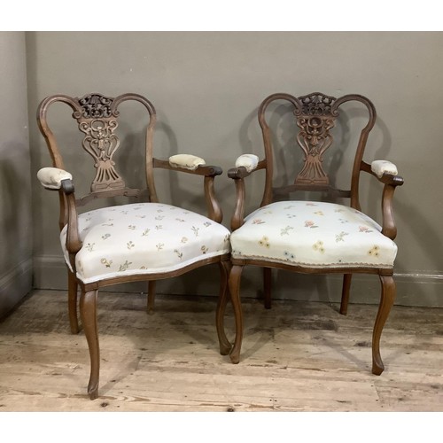 157 - A pair of continental style walnut open framed salon chairs with carved and pierced back upholstered... 