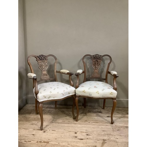 157 - A pair of continental style walnut open framed salon chairs with carved and pierced back upholstered... 