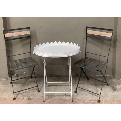 159 - A white metal garden tray topped table together with two folding garden chairs