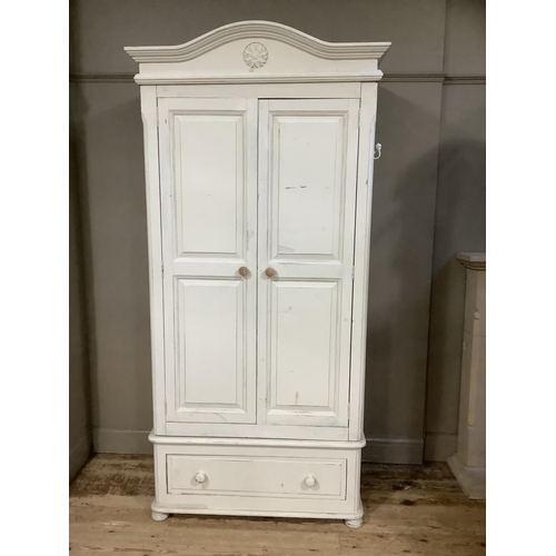 120 - A modern painted pine wardrobe, two door cupboard over a drawer, carved pediment top, 107cm wide x 2... 