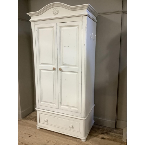 120 - A modern painted pine wardrobe, two door cupboard over a drawer, carved pediment top, 107cm wide x 2... 