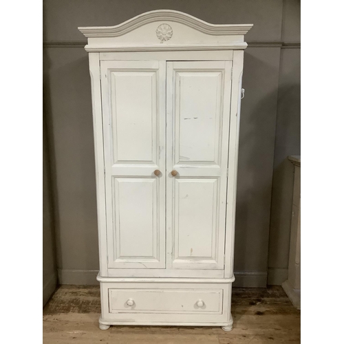 120 - A modern painted pine wardrobe, two door cupboard over a drawer, carved pediment top, 107cm wide x 2... 