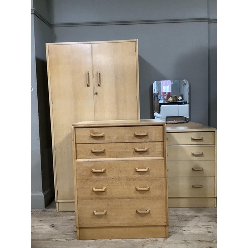 125 - A three piece G-Plan light oak bedroom suite comprising wardrobe, dressing chest and small chest