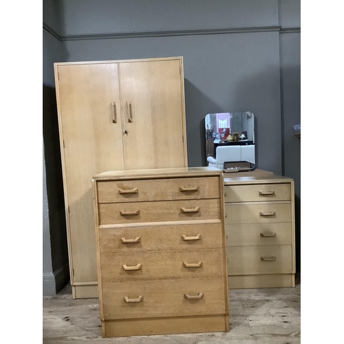 125 - A three piece G-Plan light oak bedroom suite comprising wardrobe, dressing chest and small chest