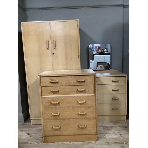 125 - A three piece G-Plan light oak bedroom suite comprising wardrobe, dressing chest and small chest