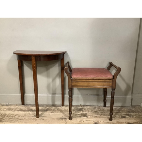 129 - A small mahogany demi lune side table together with a mahogany piano stool with lift up top