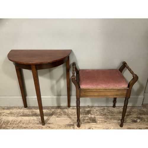 129 - A small mahogany demi lune side table together with a mahogany piano stool with lift up top