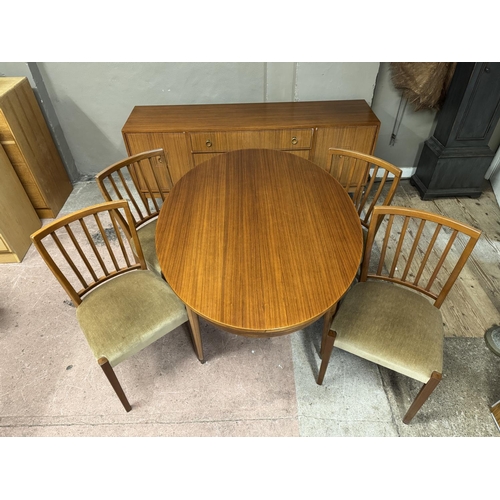 131 - A mid century teak dining suite comprising dining table and four chairs and a sideboard with two doo... 