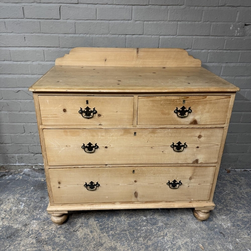 139 - A pine chest of two short above two long drawers, brass swing handles and on turned feet