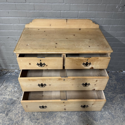 139 - A pine chest of two short above two long drawers, brass swing handles and on turned feet