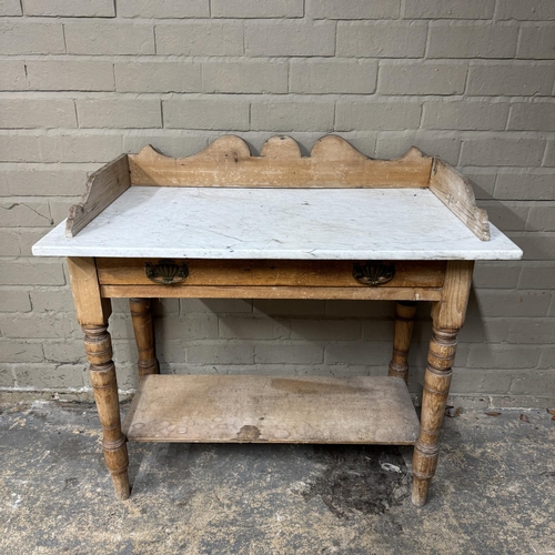 142 - A Victorian pine washstand having a marble top above single drawer, on turned legs and with pot boar... 