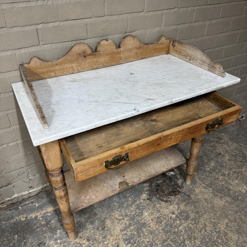 142 - A Victorian pine washstand having a marble top above single drawer, on turned legs and with pot boar... 