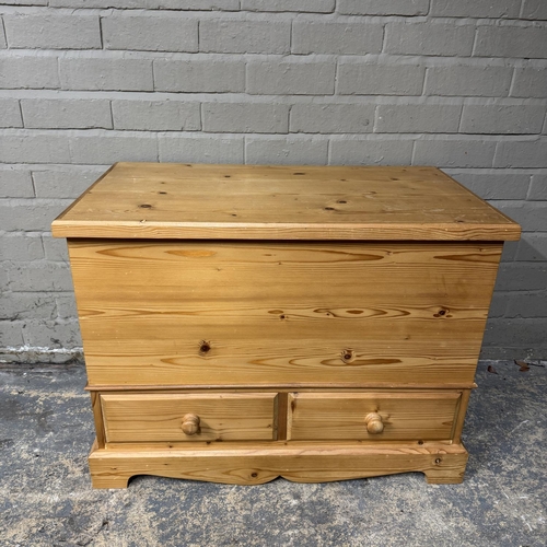 143 - A pine blanket box with lift up lid, bottom section with two drawers, on bracket feet, 83cm wide