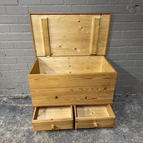 143 - A pine blanket box with lift up lid, bottom section with two drawers, on bracket feet, 83cm wide